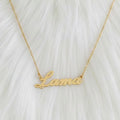 Gold necklace with 'Lama' pendant on a white fur background