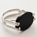 Silver ring with a black gemstone on a white background
