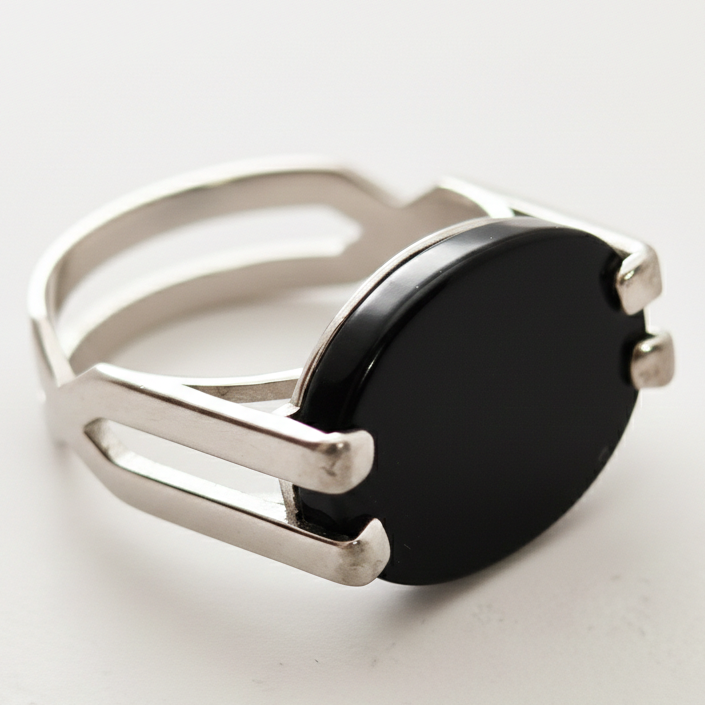 Silver ring with a black gemstone on a white background