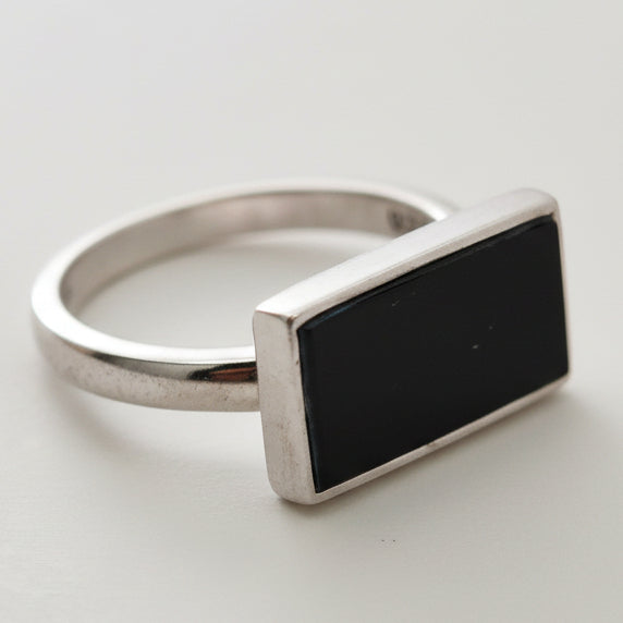 Silver keychain with a black rectangular tag on a light gray background